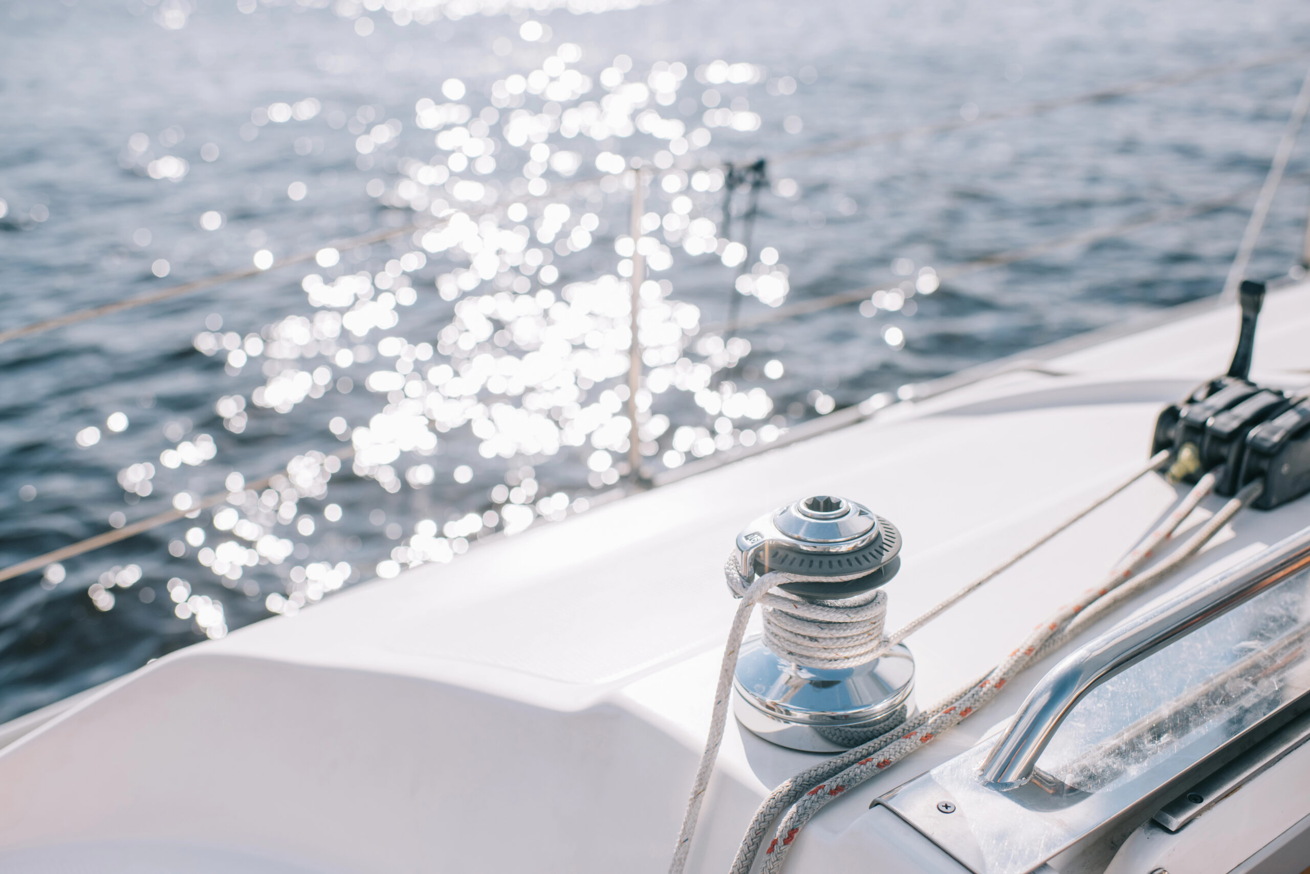 The side of a yacht over some water