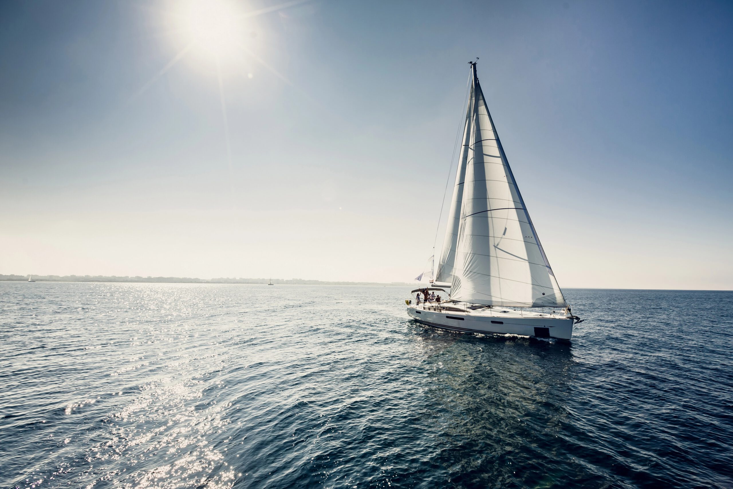 Sailing ship yachts with white sails in the open sea